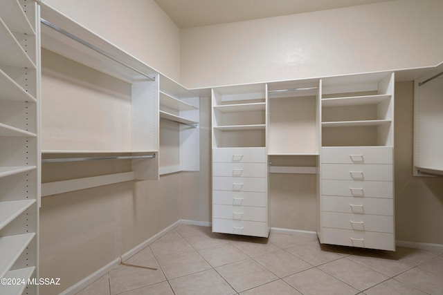 walk in closet with light tile patterned flooring