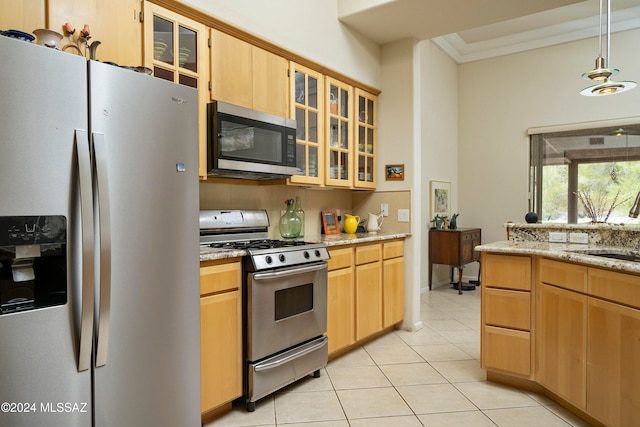 kitchen featuring light brown cabinets, light tile patterned floors, crown molding, and appliances with stainless steel finishes