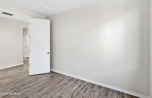 spare room with light hardwood / wood-style flooring