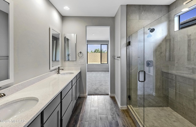 bathroom with vanity and a shower with door