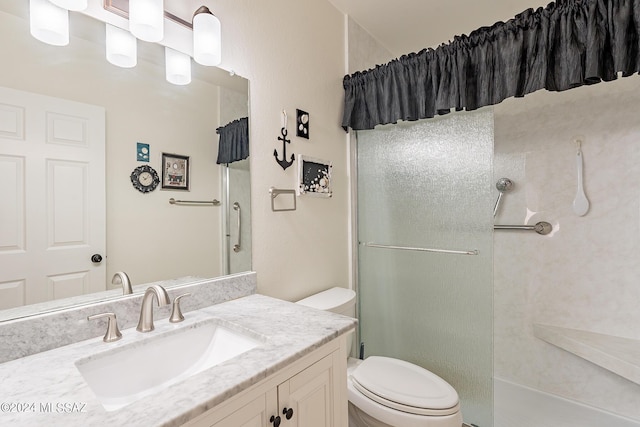 bathroom with vanity, walk in shower, and toilet