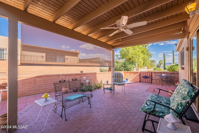 view of patio featuring fence and a ceiling fan