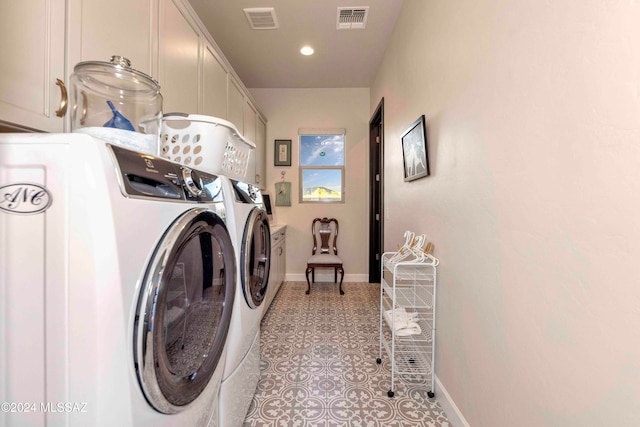 laundry room with cabinets, independent washer and dryer, and light tile patterned floors