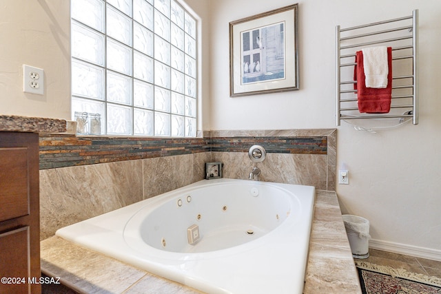 bathroom with radiator and tiled tub