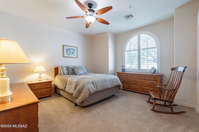 bedroom featuring light carpet and ceiling fan