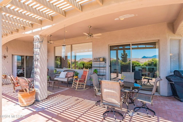 view of patio / terrace featuring a mountain view, ceiling fan, and a pergola