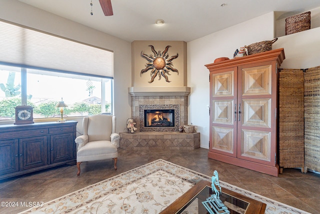 sitting room featuring a fireplace and ceiling fan