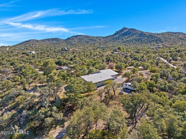 aerial view with a wooded view and a mountain view