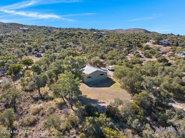 birds eye view of property featuring a mountain view and a wooded view