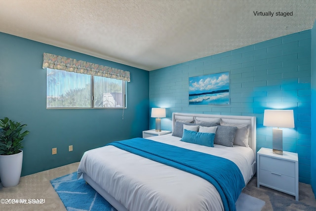 bedroom featuring a textured ceiling and carpet floors