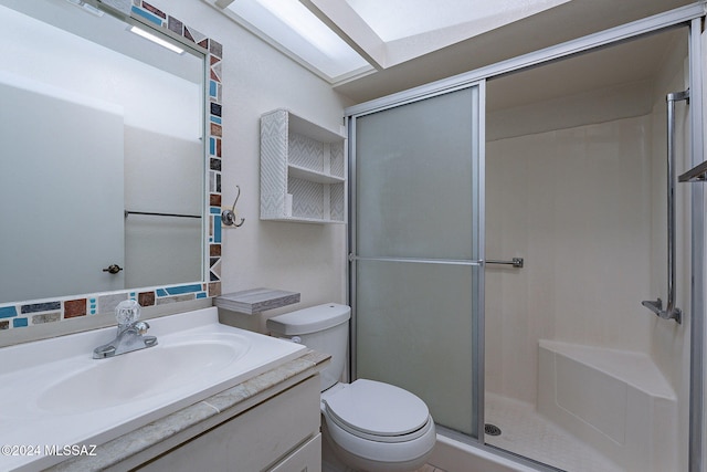 bathroom with toilet, vanity, and a shower with door