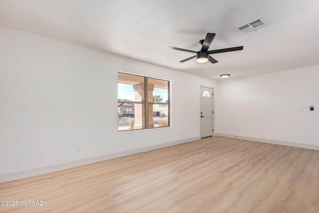 empty room with ceiling fan and light wood-type flooring