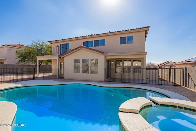 view of swimming pool with an in ground hot tub