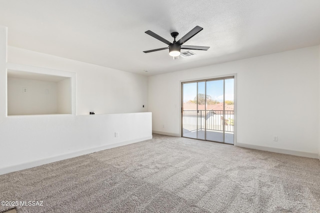 carpeted empty room featuring ceiling fan