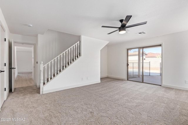 unfurnished living room featuring ceiling fan and light carpet