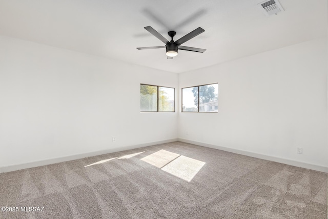 carpeted spare room with ceiling fan