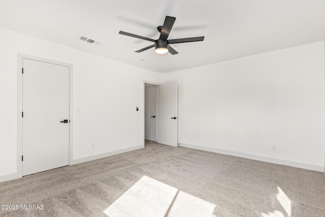 carpeted spare room featuring ceiling fan