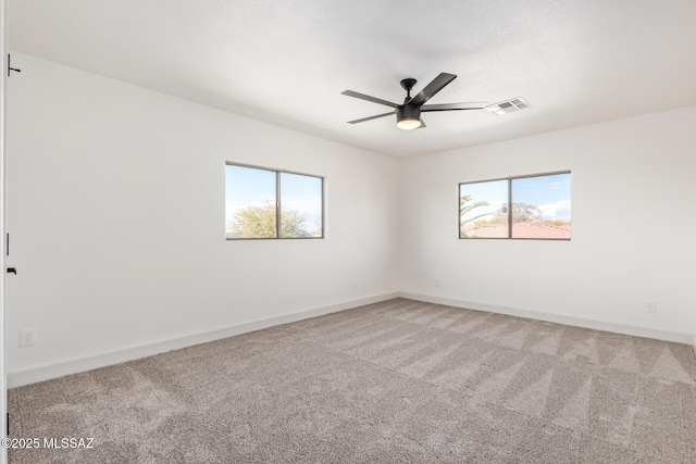 unfurnished room featuring ceiling fan and carpet