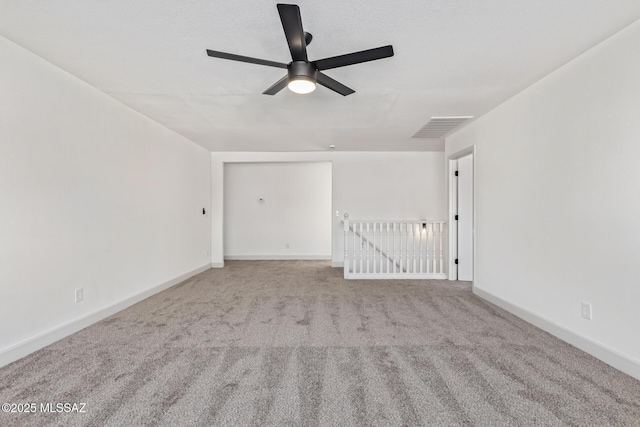 carpeted empty room featuring ceiling fan