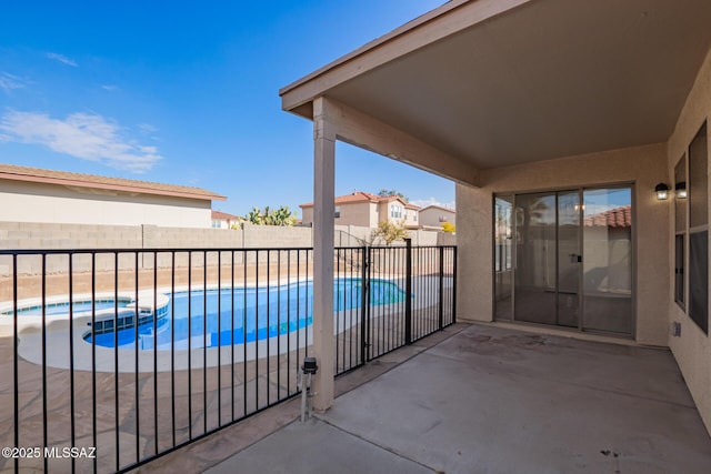 view of swimming pool featuring an in ground hot tub and a patio area