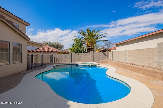 view of swimming pool with an in ground hot tub