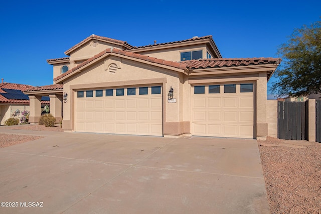 mediterranean / spanish-style house featuring a garage and solar panels