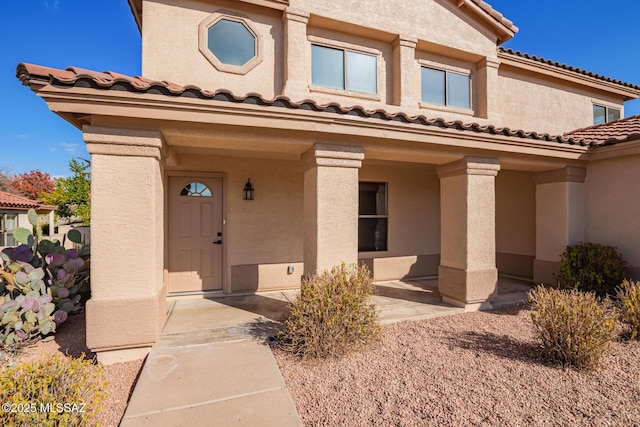 view of exterior entry featuring a patio