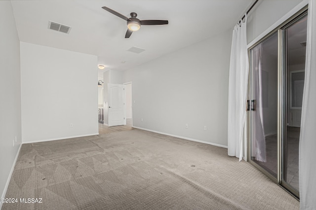 empty room featuring light colored carpet and ceiling fan