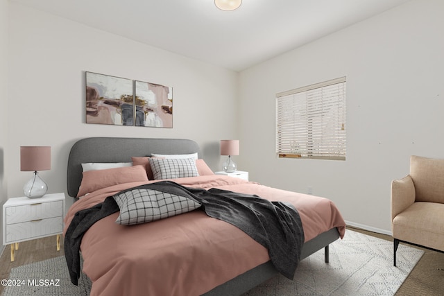 bedroom with hardwood / wood-style flooring