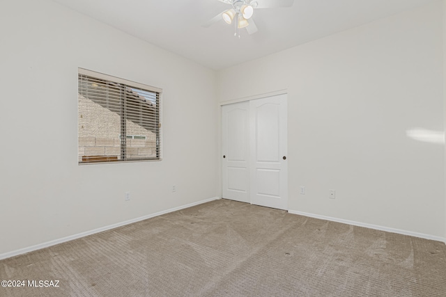 spare room featuring carpet flooring and ceiling fan