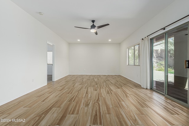 empty room with ceiling fan and light wood-type flooring