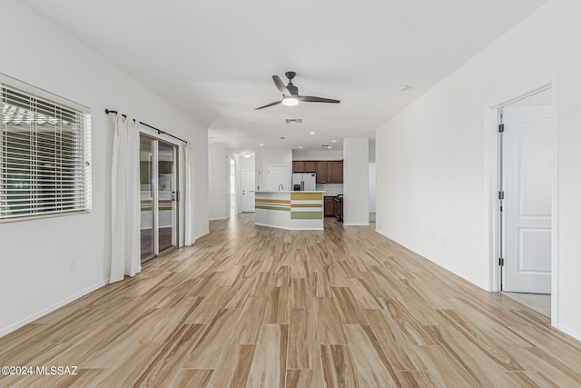 unfurnished living room with light hardwood / wood-style flooring and ceiling fan