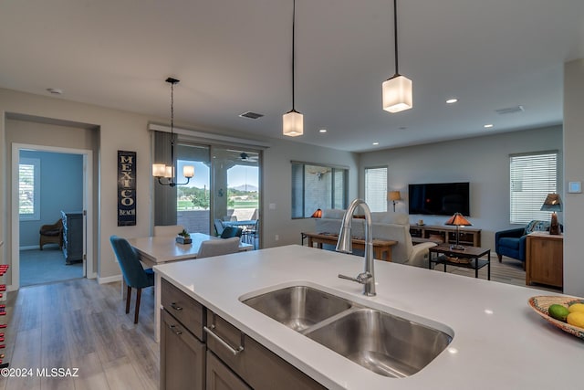 kitchen with pendant lighting, plenty of natural light, and sink