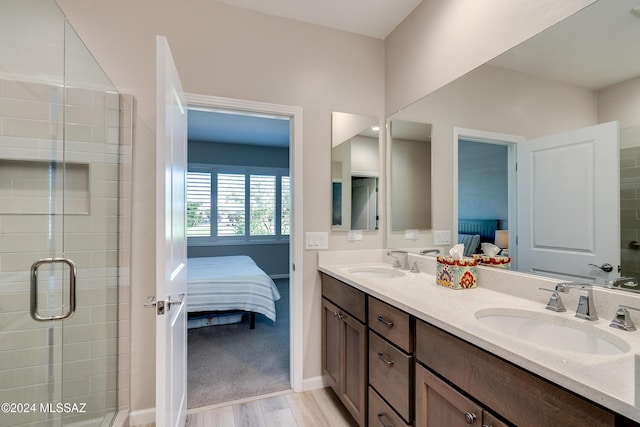 bathroom featuring hardwood / wood-style floors, vanity, and walk in shower