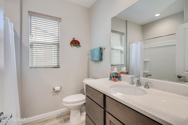 bathroom featuring a shower with curtain, vanity, hardwood / wood-style flooring, and toilet