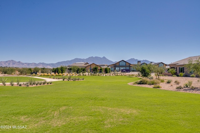 view of home's community featuring a mountain view and a yard