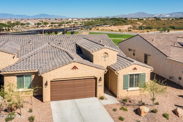 view of front of property featuring a mountain view and a garage