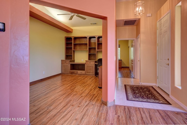 interior space featuring light hardwood / wood-style floors and ceiling fan with notable chandelier