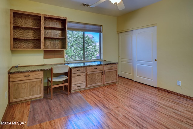 office area with light hardwood / wood-style floors, built in desk, and ceiling fan