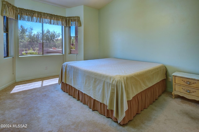 bedroom featuring light carpet