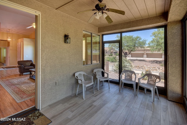 sunroom / solarium with wooden ceiling and ceiling fan