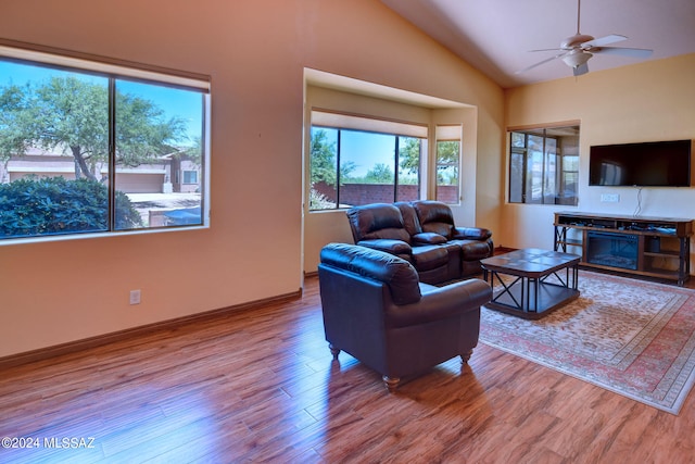 living room featuring hardwood / wood-style floors, ceiling fan, and vaulted ceiling