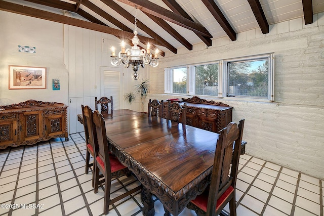 dining room featuring brick wall, high vaulted ceiling, beamed ceiling, light tile patterned floors, and an inviting chandelier