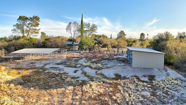 view of yard featuring a rural view and an outbuilding