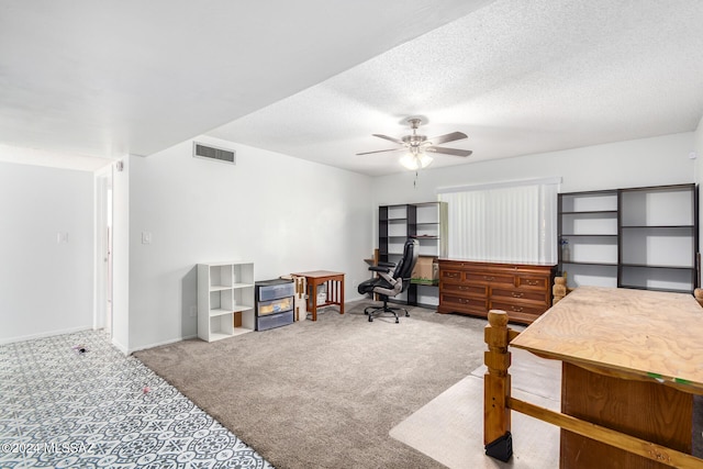 bedroom with carpet floors, a textured ceiling, and ceiling fan