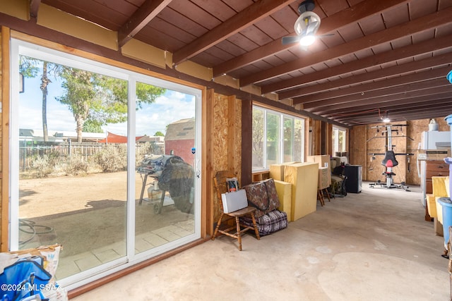 sunroom / solarium featuring ceiling fan and beamed ceiling