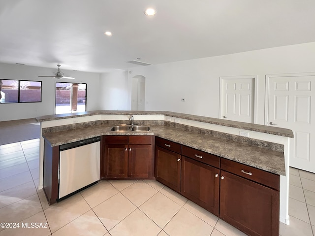 kitchen with light tile patterned flooring, sink, stainless steel dishwasher, and a center island with sink