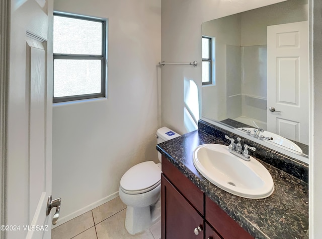 bathroom with vanity, toilet, and tile patterned floors