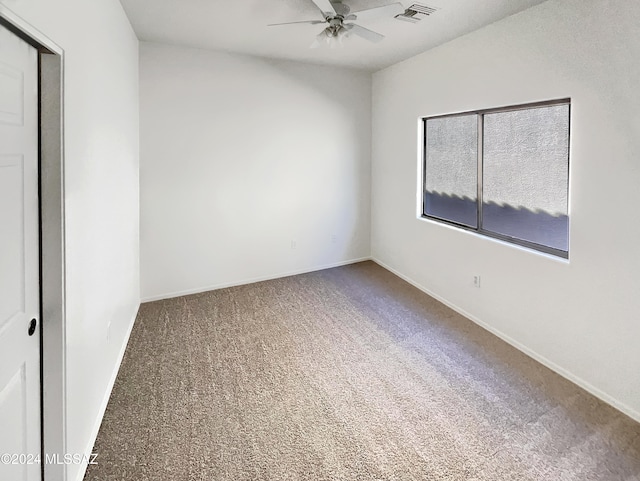 spare room with ceiling fan and carpet floors