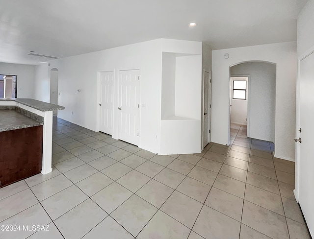 unfurnished living room with light tile patterned floors